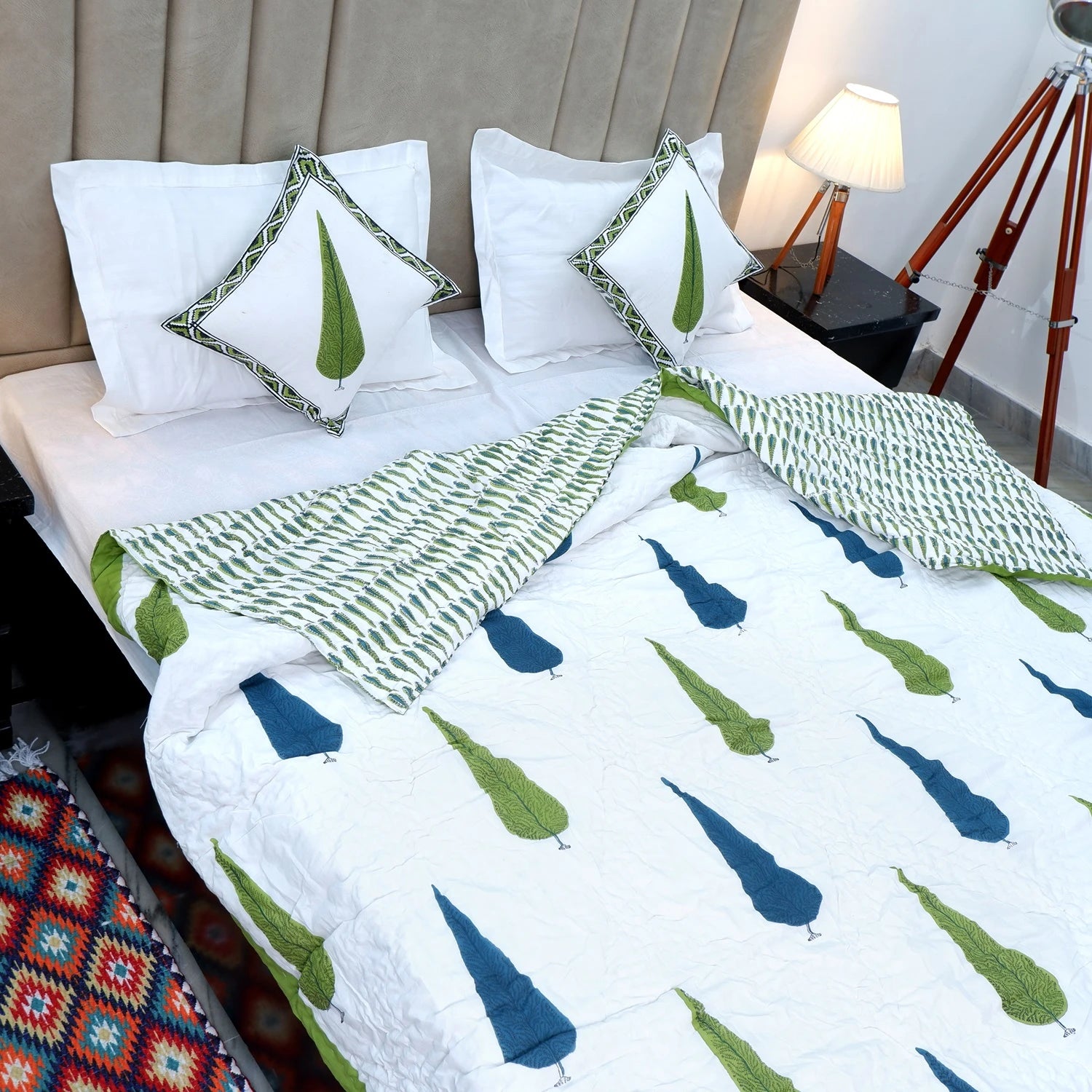 Jaipuri block print quilt set featuring a vibrant design with green and blue patterns on a white background